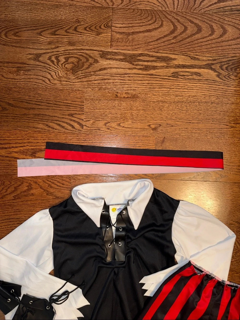Size M/8-10 pirate costume. Shirt, Pants, Belt, Boot Covers, Scarf, wrist cuffs.